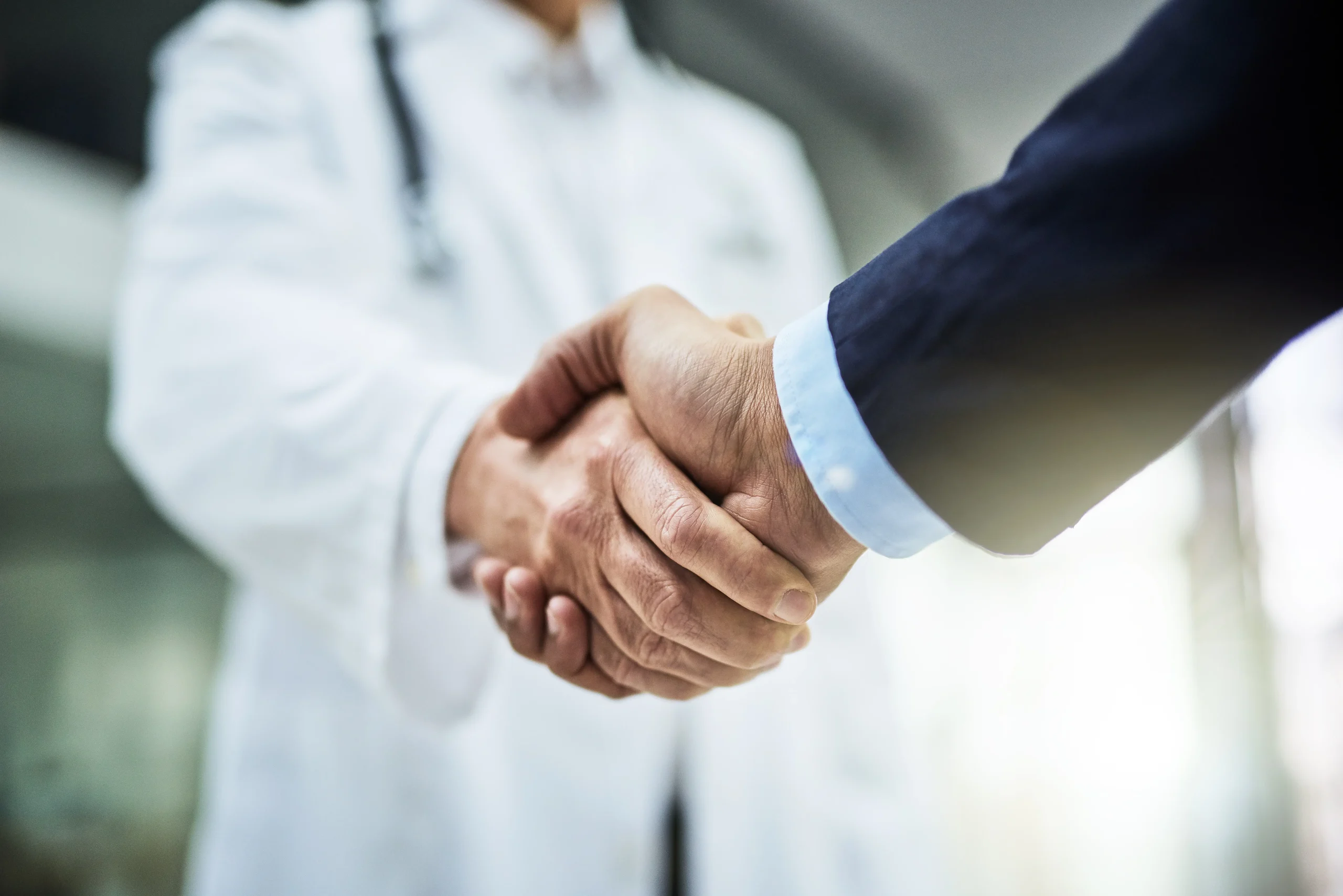 A healthcare provider and DME supplier shaking hands, representing a trusted referral partnership