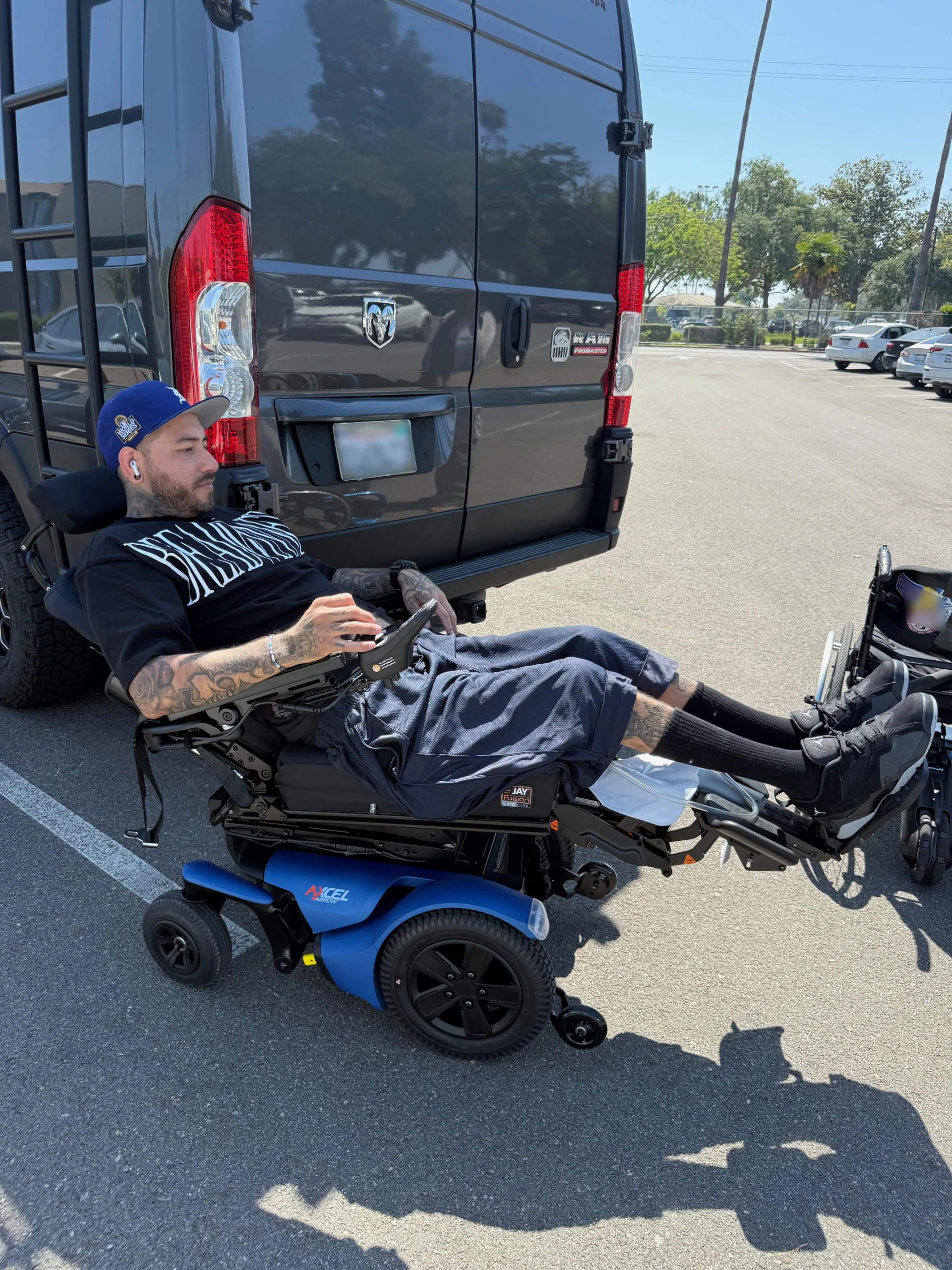 Power wheelchair in tilt and recline position with elevating leg rests, configured by Feroz Medical